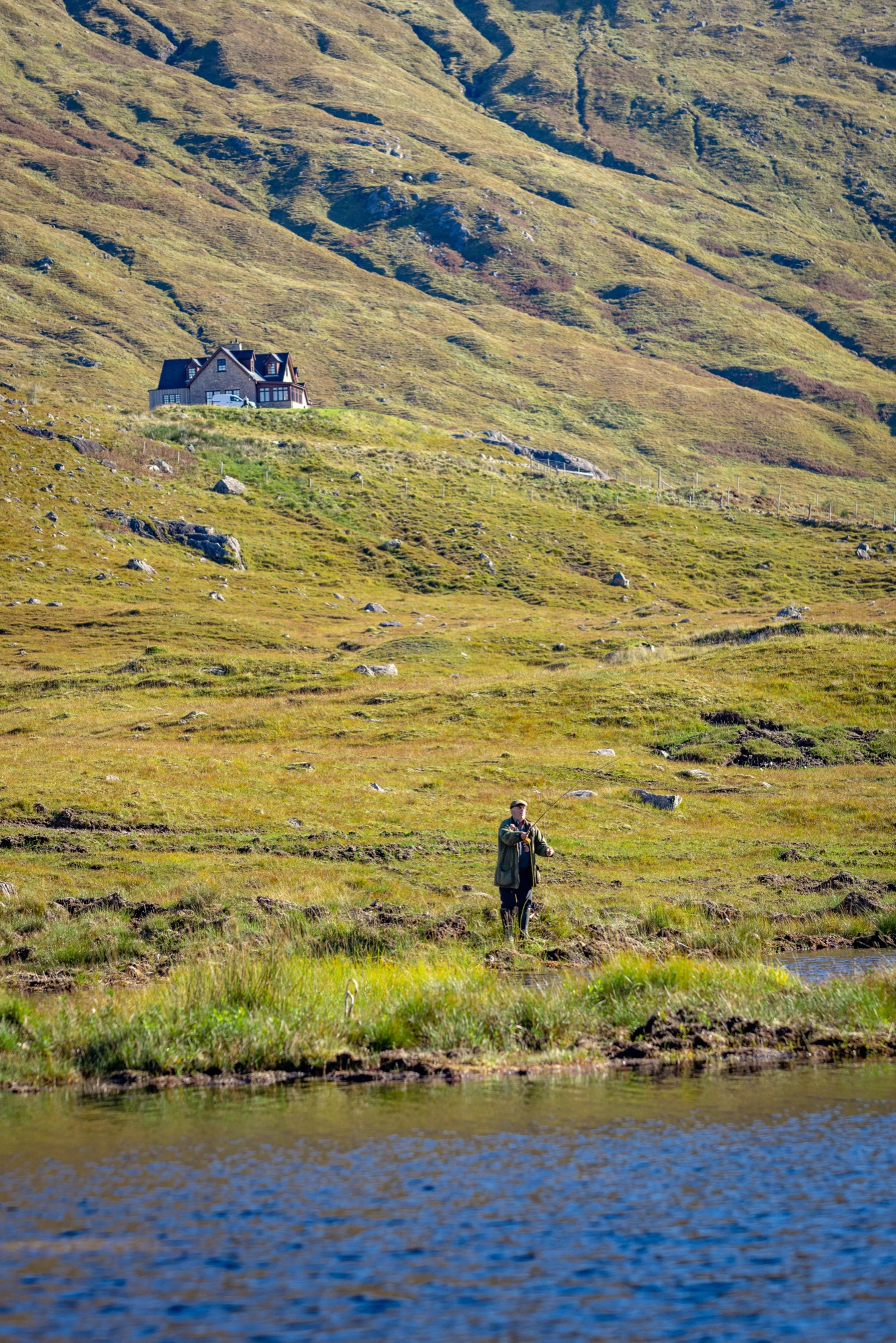 Fly fishing the Lodge loch at Glen Dessary, with the Lodge on the hillside above