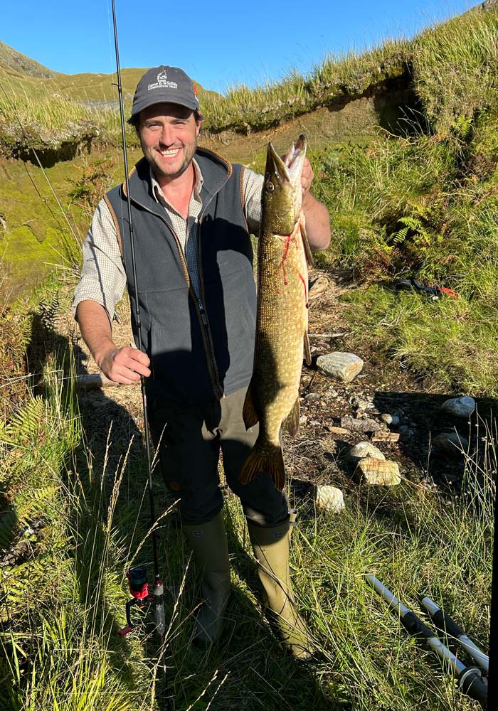 A guest with a pike taken from Glen Pean lochan at Glen Dessary Estate